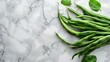 French beans lie on the white marble countertop