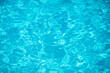 Swimming pool bottom caustics ripple and flow with waves background. Summer background. Texture of water surface. Overhead view.