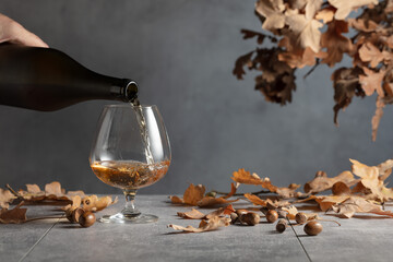 Poster - Brandy is poured from a bottle into a glass.