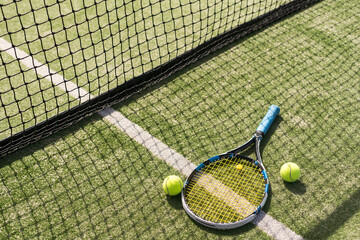 Tennis racket with a set of balls