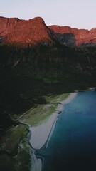 Wall Mural - Aerial view beach and sunset mountains sea nature evening scenery summer season travel beautiful destinations, vertical video 