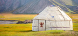 Fototapeta  - Yurt. National old house of the peoples of Kyrgyzstan and Asian countries. national housing. Yurts on the background of green meadows and highlands. Yurt camp for tourists.