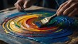 painting a colorful swirl on a wooden table, paints mixing. Abstract background 