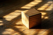 A single, closed mystery box resting on a plain wooden table, casting a faint shadow.
