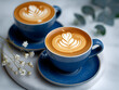 Artistic Latte Art on Two Cups of Coffee with a Blue Background