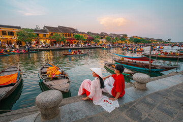 Asian Couple wearing vietnam  traditional culture  walking around at Hoi An ancient town,Hoi an city in Vietnam.