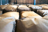 Fototapeta Sawanna - Warehouse full of paper sacks with tea. Producing process in tea factory in Sri Lanka..