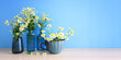 spring bouquet of daisies flowers over wooden table and blue background