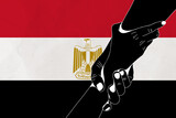 Helping hand against the Egypt flag. The concept of support. Two hands taking each other. A helping hand for those injured in the fighting, lend a hand