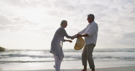 Canvas Print - Couple, dancing and fun on beach, bonding and vacation or holiday, relaxing and romance or laugh. People, freedom and support in marriage, hug and travel to outdoors, ocean and love in partnership