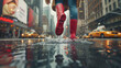 Close up of a woman in red rain boots jumping into a puddle on the street during rainy weather with a city background