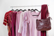 women's clothing in pink and burgundy trendy colors on a hanger
