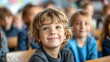 © Mechastock - Portrait of a young child in a classroom eager to learn