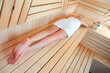Young woman relaxing in sauna, top view. Spa treatment concept