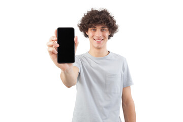 Smiling and handsome, the young man showing the blank screen of his smartphone to the camera, while looking into the camera with his blue eyes, isolated against a white background