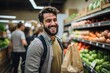 happy young man shopping fruits and vegetables in a supermarket