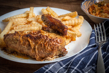 Wall Mural - Roasted chicken with french fries on a plate.