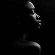 © JetHuynh - Black background Rim light a young black woman in profile photography, with the light shining on her face