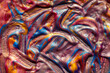 Closeup of golden, blue and pink fluid metallic acrylic paint textured background