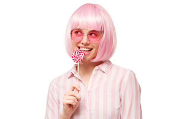 Funny woman with pink hair and eyeglasses, holding red and white lollipop candy