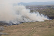 Fire burning in Dry grass field with smoke