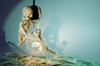 A funny and clever skeleton swinging on a light bulb, against a green background, campaigns to green energy, ecology, and money save. Free space for text