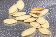 Pumpkin seeds on a glittery silver background