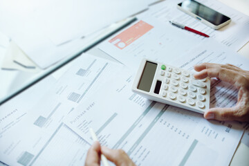 close-up shot. business owner use calculator to manage financial documents bills invoices pay utilit