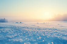A Snowy Field With A Bright Blue Sky And A Sun In The Background