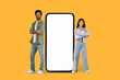 © Prostock-studio - Two people next to a large smartphone mock