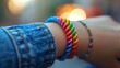 A closeup of a rainbow wristband worn by someone at a Pride event
