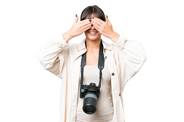 Wall Mural - Young photographer caucasian woman over isolated chroma key background covering eyes by hands