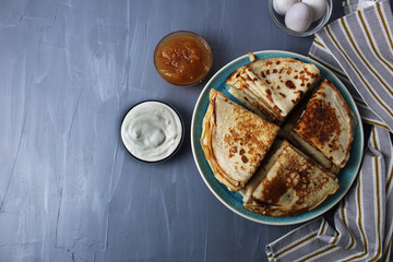 Canvas Print - French breakfast with crepe pancakes with sour cream and jam on grey background with space for copy space text