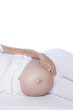 © Kostia - Happy pregnant girl lies on white background