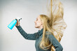 Girl messy hair holding spray bottle