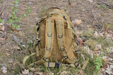 Fototapeta Desenie - one brown army backpack standing on a earth outdoors in nature