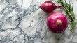 Bulbs of onion lie on the white marble countertop