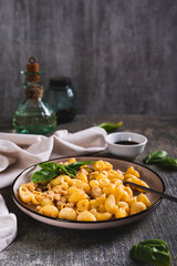 Canvas Print - Delicious pasta with minced meat and basil on a plate on the table vertical view