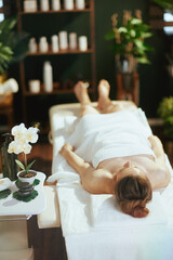 Poster - relaxed modern woman in massage cabinet laying on massage table