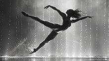   A Monochrome Image Of A Woman Dancing In The Rain, Arms Extended, Feet Apart
