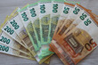 European Union banknotes spread out on the desk, 50, 100, 200 euros