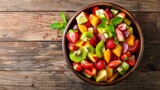 Fototapeta  - Refreshing fruit salad in a bowl, shot from above