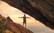 Traveler young man open arms standing in summer mountains enjoying view of ocean sunrise feeling free, inspired, empowered 
