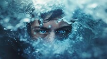 A Person's Eyes Are Visible Above The Surface Of Churning Blue Water. The Water Is Filled With Bubbles And Creates A Textured Layer Over The Face, Which Is Partially Obscured. The Eyes Are Strikingly 