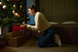 Side view of woman taking gift under christmas tree during Christmas or New Year