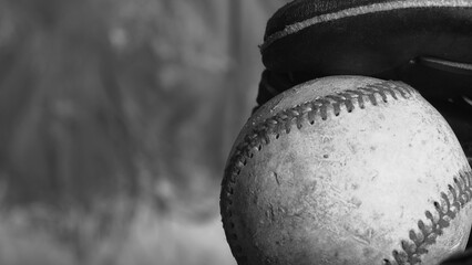 Sticker - Old baseball in glove with copy space on black and white background for league game concept.