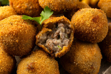 Fried Homemade beef Bitterballen with dijon mustard, ketchup and french fries