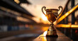 Trophy cup on railing with blurred sunset background