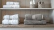 Stack of neatly folded white and grey towels on shelf in modern bathroom