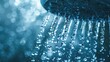 Close-up of water droplets falling from shower head, with blue tint